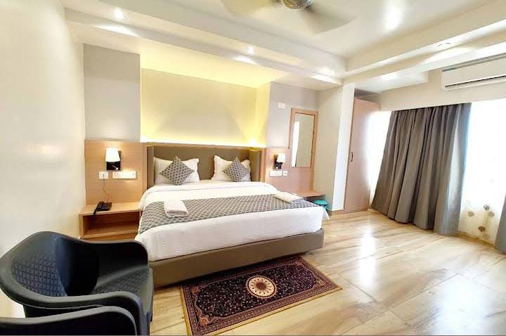 Comfortable king bed suite with lounge chair